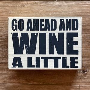 **LAST CALL** “Go Ahead and Wine a Little” sign.